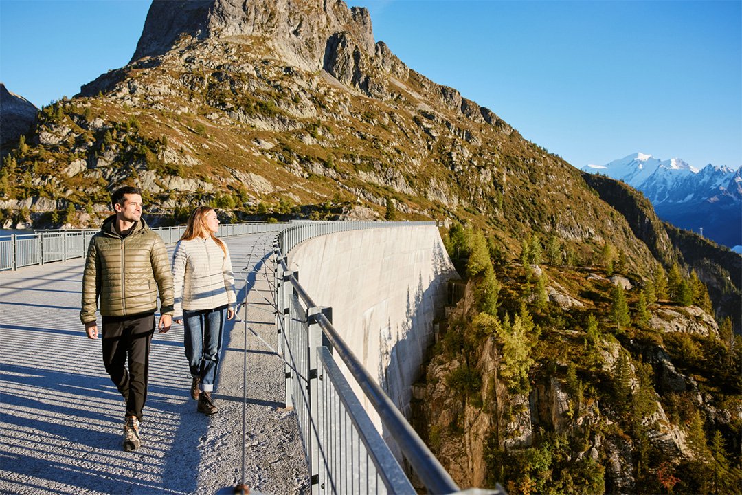 Two people walking on dam during autuum