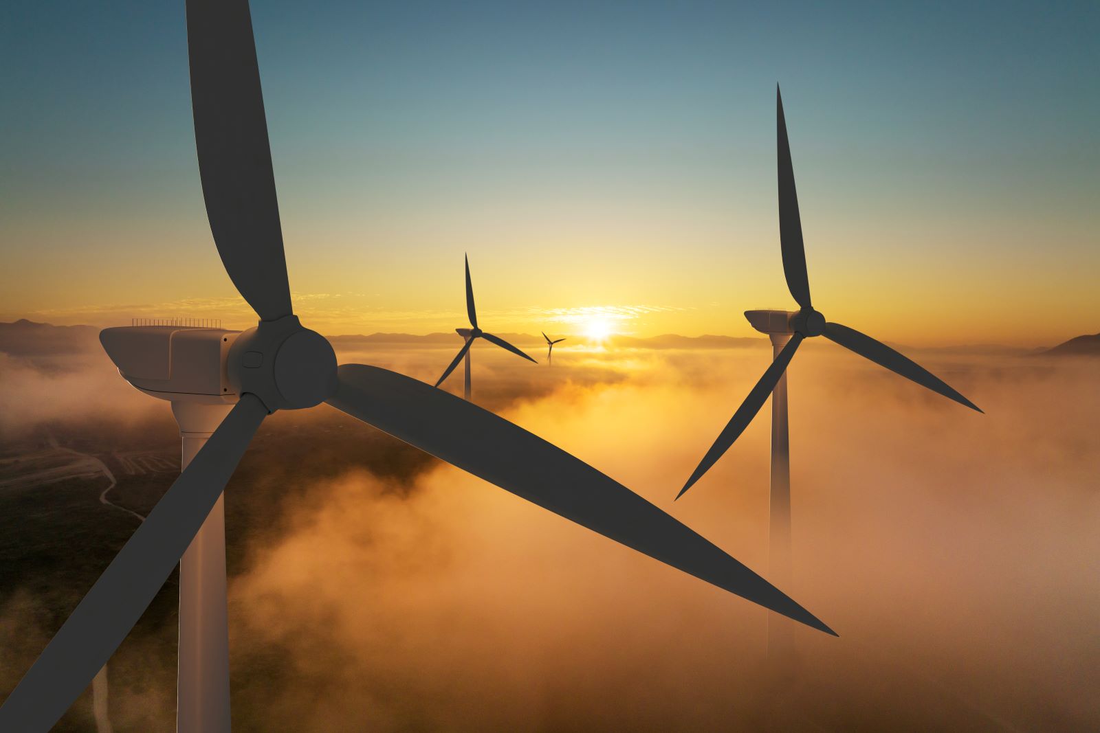 4 wind turbines over the clouds while the sun sets