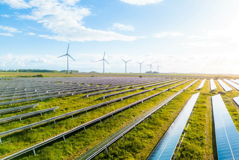 a field of solar power and wind turbines