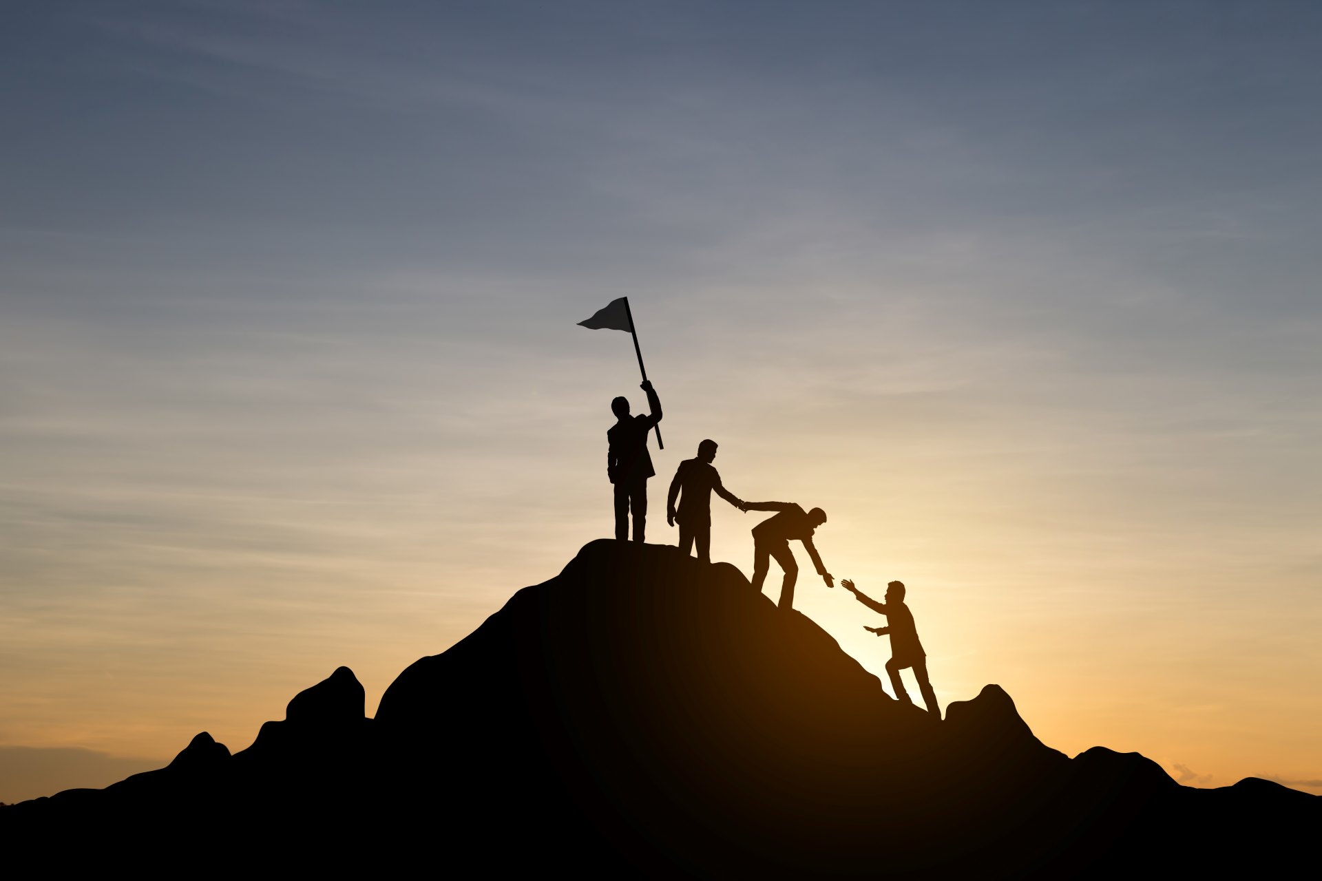 Group climbing a mountain and helping each other