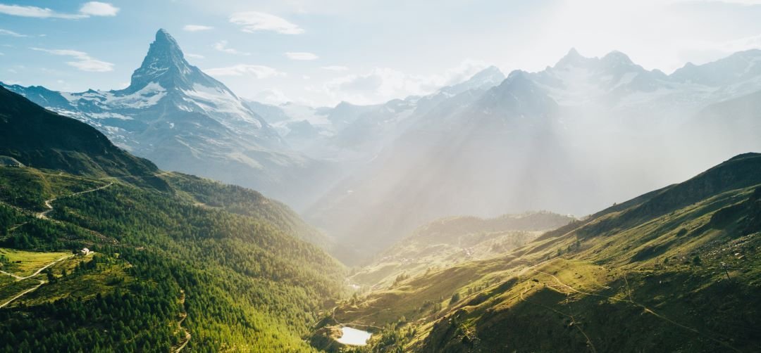 a beautiful picture of a valley with the matterhorn in the background