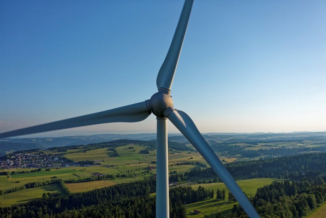 A picture of a wind turbine with a blue sky