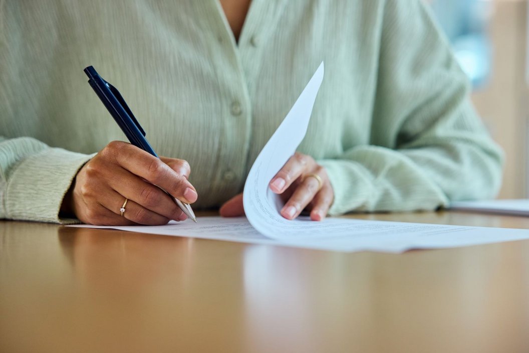 Person writing something on paper