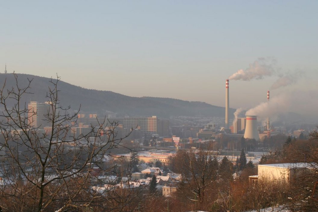 a Czech City covered in snow with a asset in the background