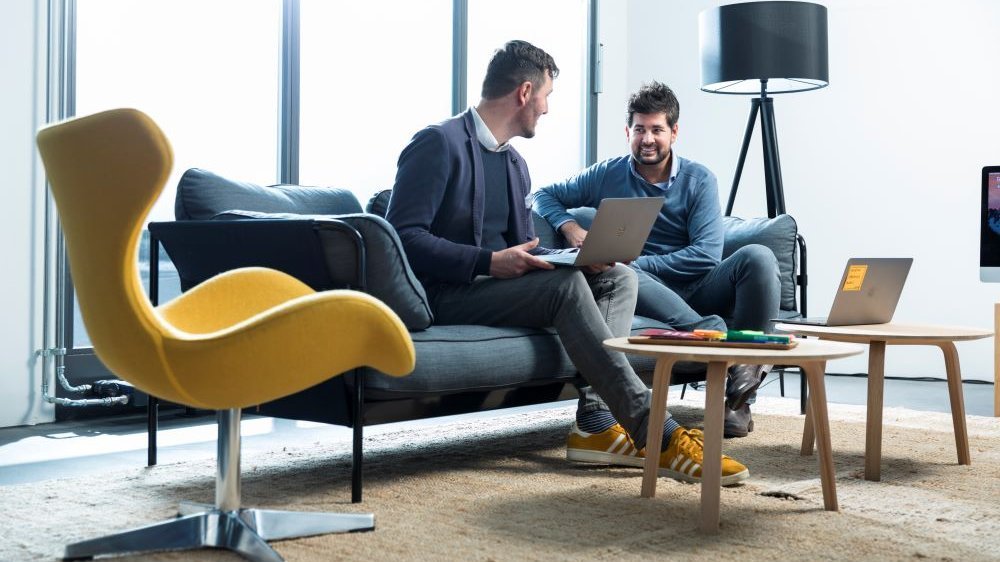 two men talking in a modern meeting room