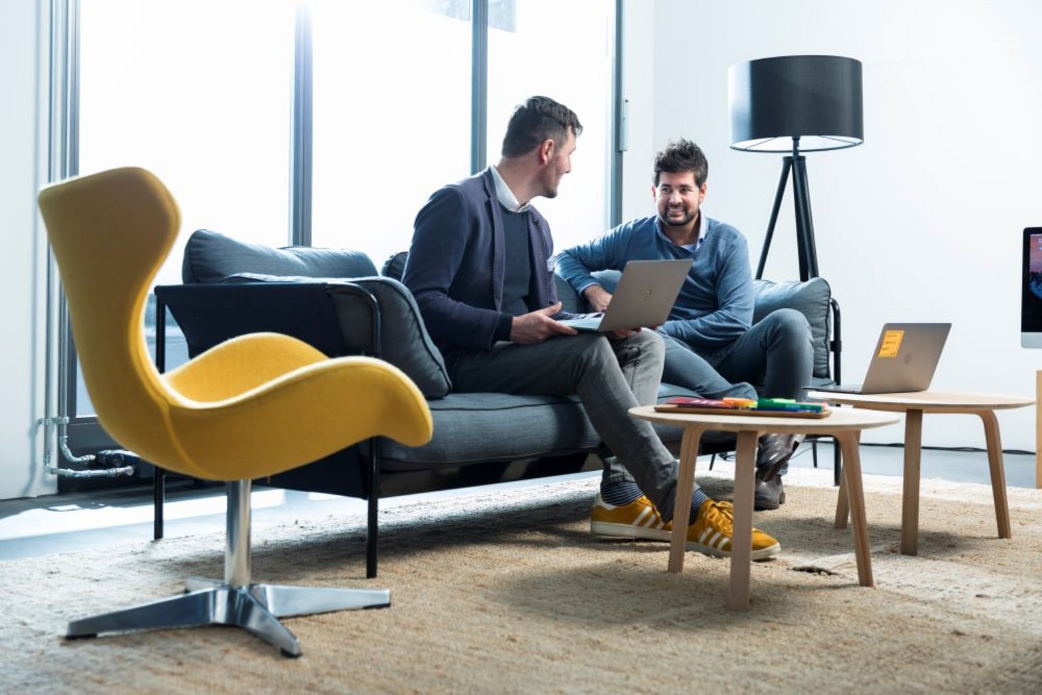 two men talking in a modern meeting room